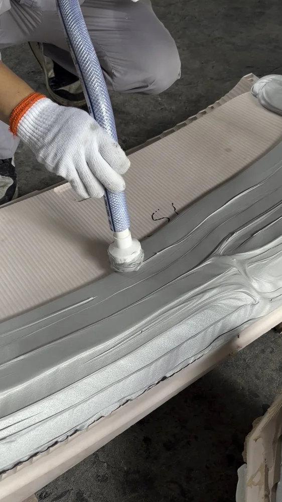 An operator applying modelling paste onto a shaped substrate